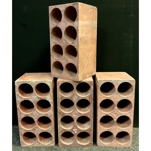 86 - A set of four terracotta eight bottle wine-cellar racks, each measuring 45cm high x 22.5cm x 22.5cm,... 