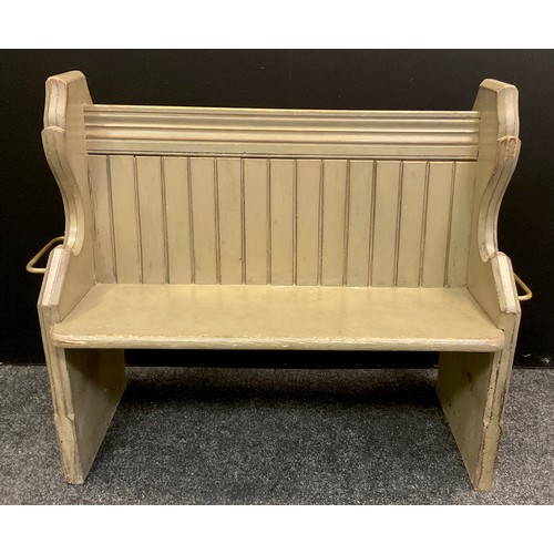 90 - A small painted pine pew, shaped ends, brass carrying handles,  92cm high, 120cm wide, 50cm deep.