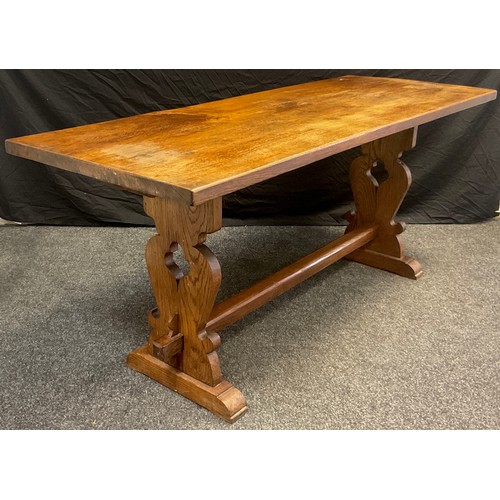 94 - An early 20th century oak trestle table, 71cm high x 166.5cm x 61.5cm;  and a set of footprints oak ... 