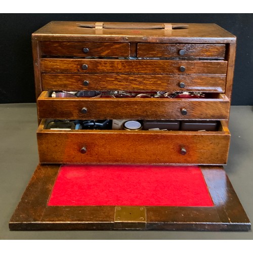 114 - A Peckhams's oak Engineers/Watch makers tool box containing a large quantity of assorted watch spare... 