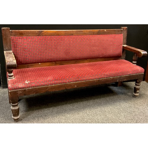 128 - An early 20th century pine railway station Waiting-room type bench, upholstered back and seat, turne... 