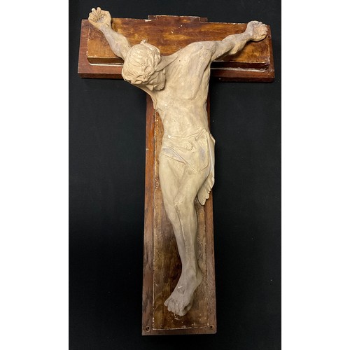 137 - A plaster wall plaque, Christ Crucified, in white on a brown patinated cross and oak back board, ind... 