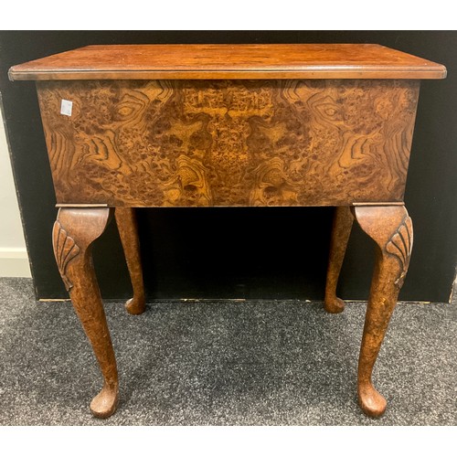 146 - A reproduction burr elm lowboy, oversailing top above three frieze drawers, shaped apron, shell carv... 