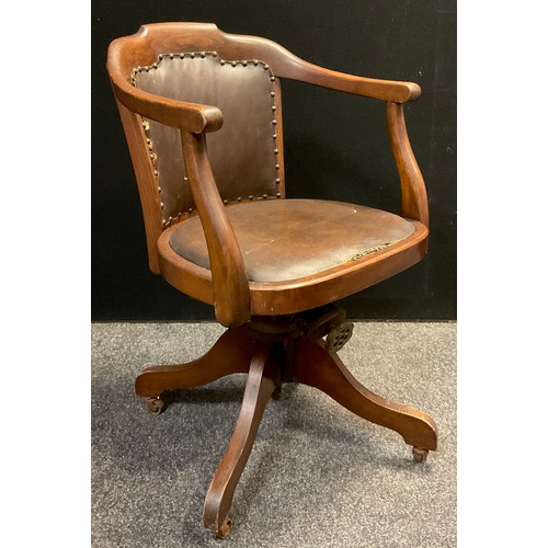 151 - A mid 20th century beech office desk chair, tilt and revolve seat.