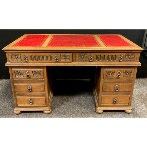 158 - A oak pedestal desk, faux red leather inset writing surface, over-sailing top, pair of long frieze d... 