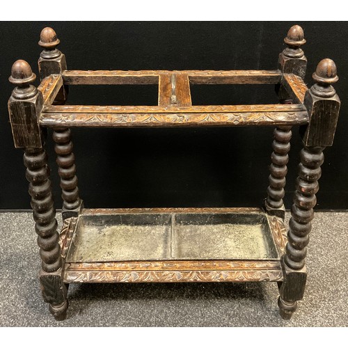 169 - An early 20th century carved oak umbrella /stick stand, two section top, turned columns terminating ... 