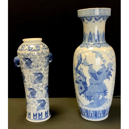 119 - A Chinese blue and white waisted cylinder vase, decorated with carp swimming, twin mask handles, 46c... 