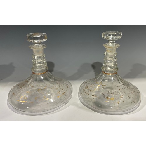 7 - A pair of Georgian ships decanters, each with octagonal stopper, four collar neck, faceted shoulder,... 