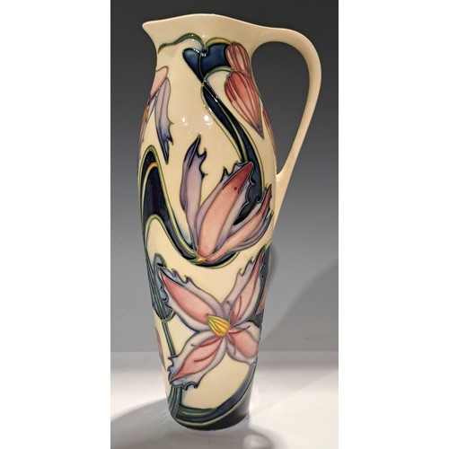 13 - A contemporary Moorcroft single handled jug, signed by Philip Gibson, tube lined with pink and lilac... 