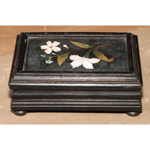 23 - An Italian pietra dura and ebonised casket, hinged cover set with a panel inlaid with a spray of flo... 