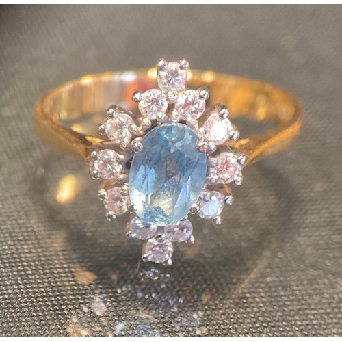 748 - An aquamarine and diamond cluster ring, 18ct gold shank