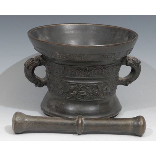 55 - A Dutch bronze pestle and mortar, cast with birds and scrolling foliage, inscribed beneath the rim H... 