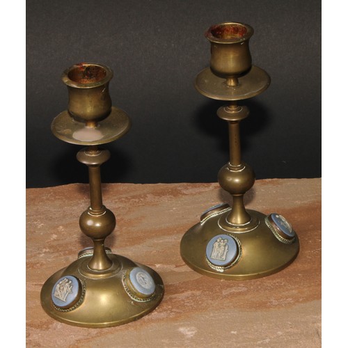 57 - A pair of 19th century jasperware mounted brass candlesticks, the cabochons sprigged in the Grand To... 