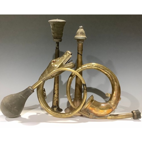 62 - Automobilia - a coiled brass car horn, modelled as a snake; another coiled brass car horn; a Trico c... 