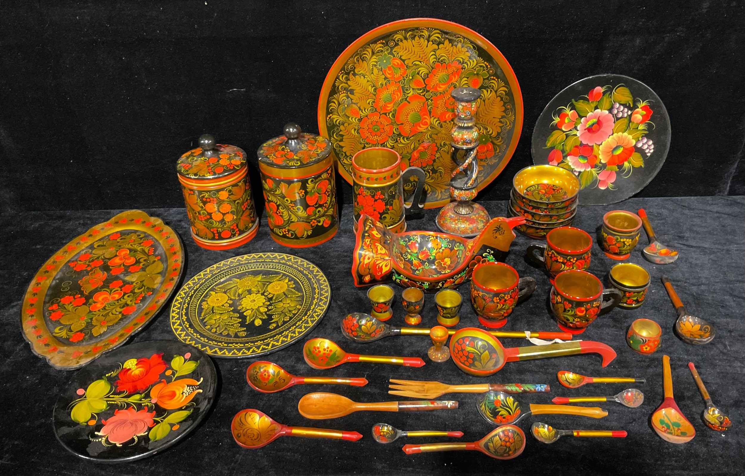 A collection of Russian Khokhloma ware, including a jars, plates, a ...