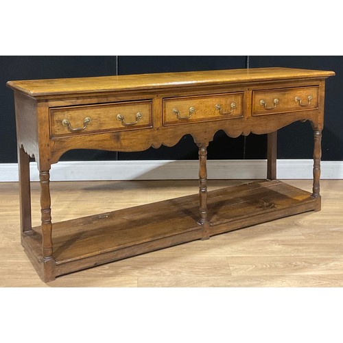 107 - A George III style oak low potboard dresser, rectangular top above three frieze drawers, 78.5cm high... 