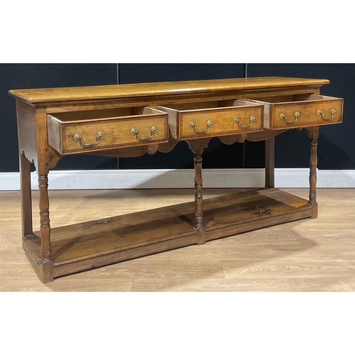 107 - A George III style oak low potboard dresser, rectangular top above three frieze drawers, 78.5cm high... 