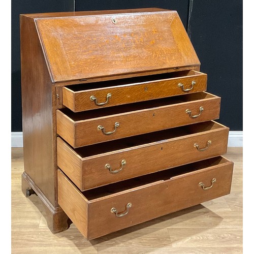 118 - A George III oak bureau, fall front enclosing small drawers and pigeonholes, above four long graduat... 