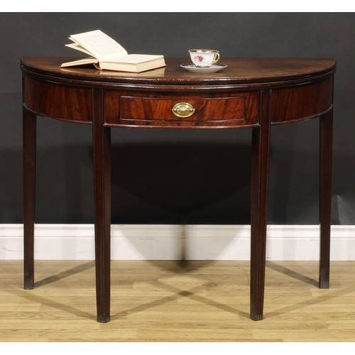 212 - A George III mahogany demilune tea table, hinged top above a single frieze drawer, tapered legs, 73c... 