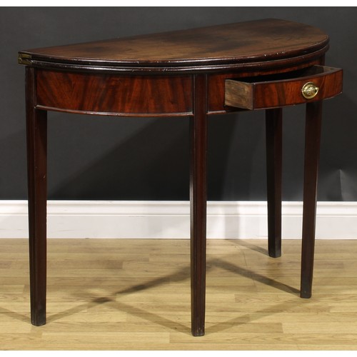 212 - A George III mahogany demilune tea table, hinged top above a single frieze drawer, tapered legs, 73c... 