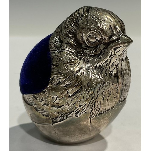 917 - A silver plated novelty miniature pincushion, modelled as a chick emerging from an eggshell, 4cm hig... 