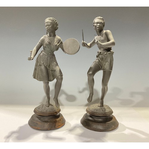 952 - A pair of early 20th century spelter figures, as an African musician and dancer, turned wood bases, ... 