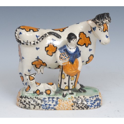 21 - A James Emery Pottery Mexborough cow, calf and milkmaid group, decorated in the typical Pratt ware/P... 