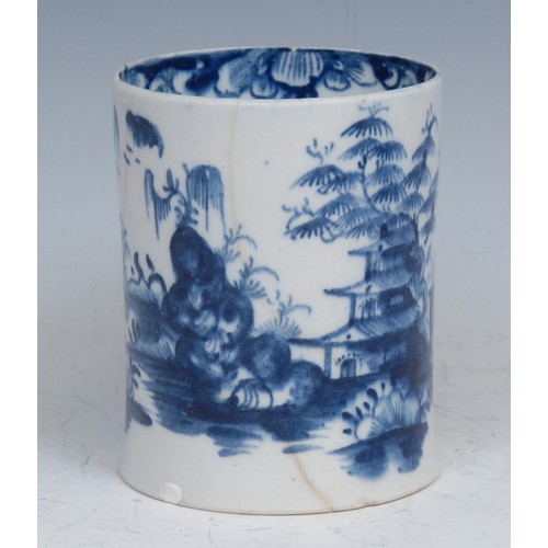 46 - An early Lowestoft mug, painted in underglaze blue with Chinese landscape, the interior rim with a b... 