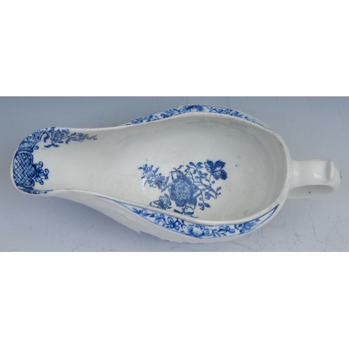 39 - A Lowestoft sauceboat, moulded in relief with flowerheads, decorated in underglaze blue with flowers... 