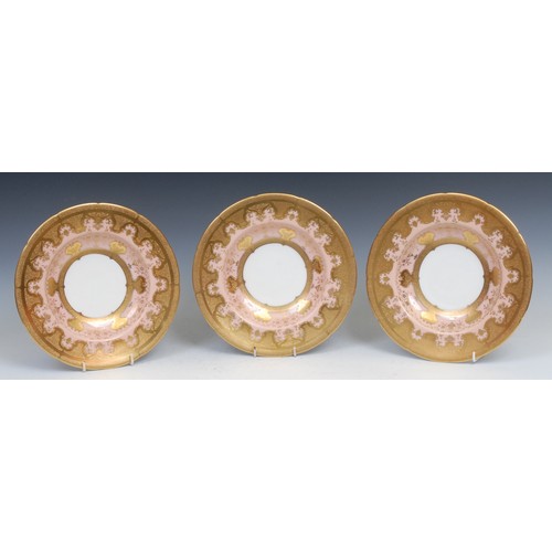 51 - A set of three Coalport shaped circular dishes, each profusely decorated with tooled and burnished g... 