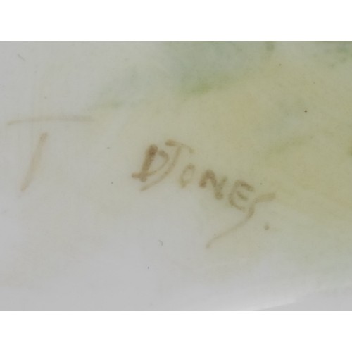 99 - A Royal Worcester teacup and saucer, painted by D. Jones, signed, with a chaffinch and a yellow hamm... 