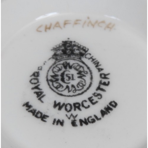 99 - A Royal Worcester teacup and saucer, painted by D. Jones, signed, with a chaffinch and a yellow hamm... 