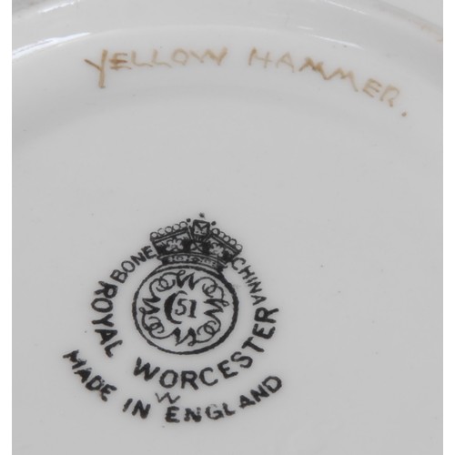 99 - A Royal Worcester teacup and saucer, painted by D. Jones, signed, with a chaffinch and a yellow hamm... 