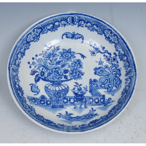 103 - A Worcester Bat pattern tea bowl and saucer, decorated in underglaze blue with a chinoiserie garden,... 