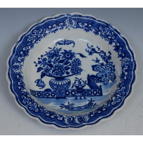 103 - A Worcester Bat pattern tea bowl and saucer, decorated in underglaze blue with a chinoiserie garden,... 