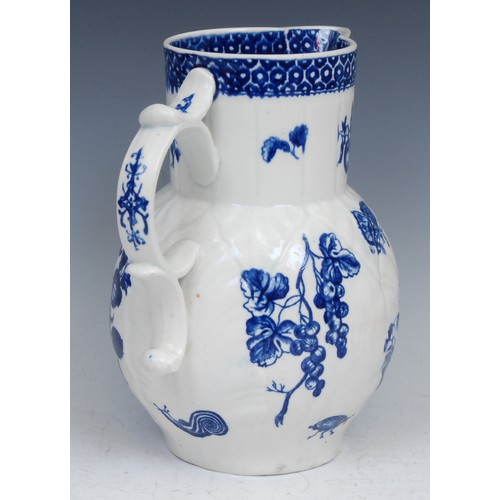 107 - A Worcester Parrot Pecking Fruit pattern cabbage leaf jug, mask spout, decorated in underglaze blue ... 