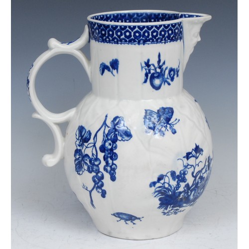 107 - A Worcester Parrot Pecking Fruit pattern cabbage leaf jug, mask spout, decorated in underglaze blue ... 