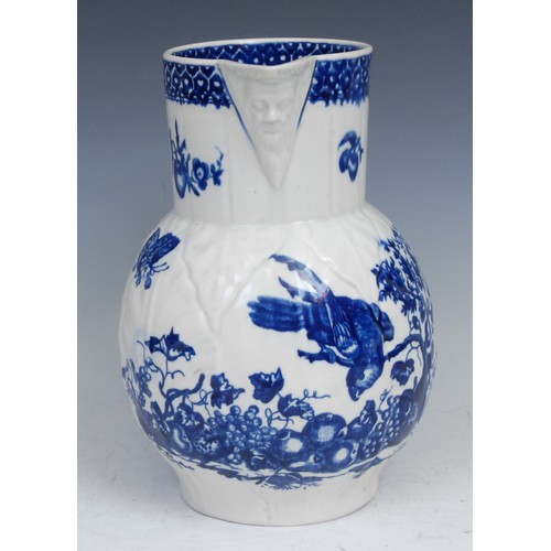107 - A Worcester Parrot Pecking Fruit pattern cabbage leaf jug, mask spout, decorated in underglaze blue ... 