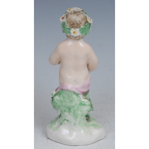 114 - A Derby patch mark figure, Putto, garlanded with flowers, 10cm high, c.1780