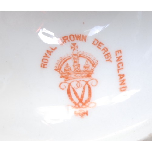 130 - A Royal Crown Derby ovoid pedestal vase, painted with an urn of flowers, picked out in gilt on a blu... 