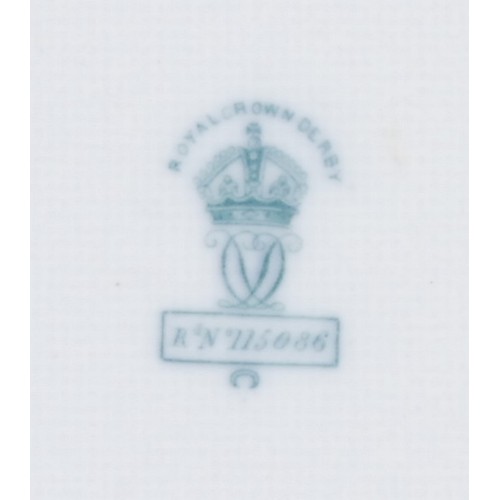 126 - A pair of Royal Crown Derby shaped circular plates, painted with central sprays of dog roses on crea... 