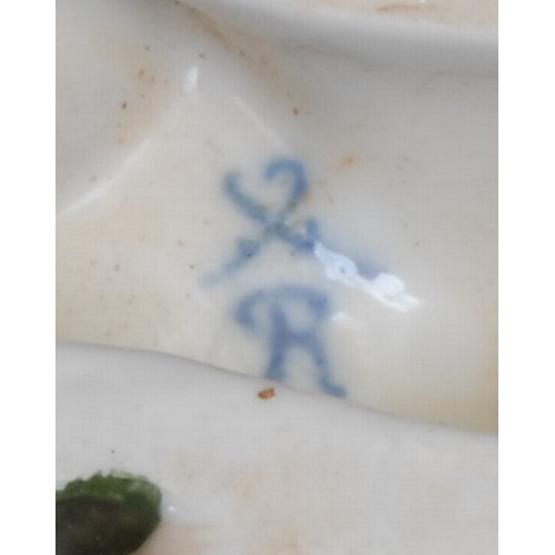 166 - A pair of Continental porcelain vases, each modelled with flowers supported by scantily clad putti, ... 