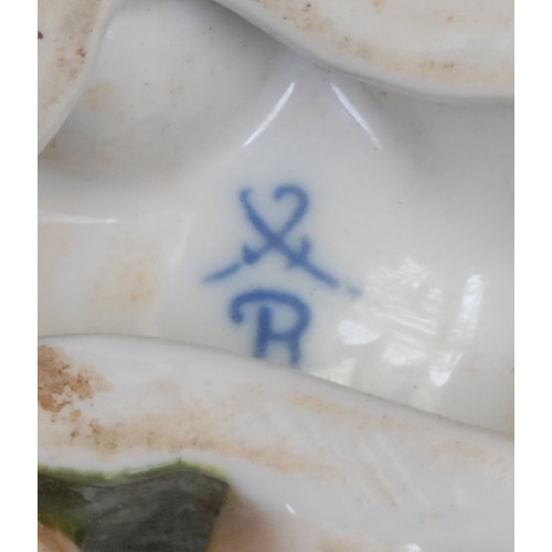 166 - A pair of Continental porcelain vases, each modelled with flowers supported by scantily clad putti, ... 