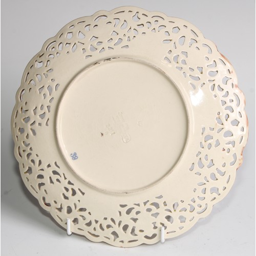 174 - A pair of Zsolnay Pecs shaped circular plates, each decorated in polychrome with stylised flowers, r... 