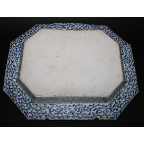 211 - A 19th century Chinese canted rectangular dish, the field painted in polychrome enamels with fancifu... 