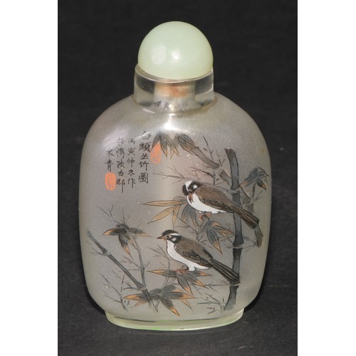 243 - A Chinese inside painted flattened ovoid snuff bottle, decorated with verse, and birds amongst bambo... 