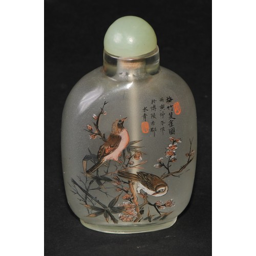 243 - A Chinese inside painted flattened ovoid snuff bottle, decorated with verse, and birds amongst bambo... 