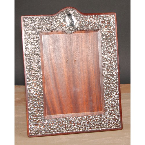 An Edwardian silver easel photograph frame, pierced and embo...