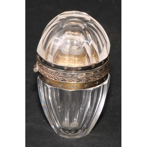 1184 - A French silver coloured metal mounted rock crystal faceted ovoid scent bottle, hinged cover enclosi... 