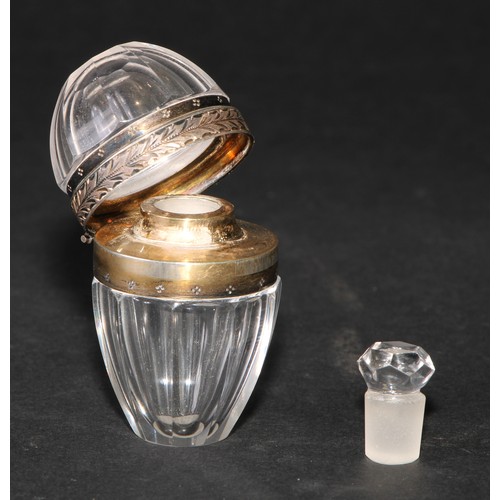 1184 - A French silver coloured metal mounted rock crystal faceted ovoid scent bottle, hinged cover enclosi... 